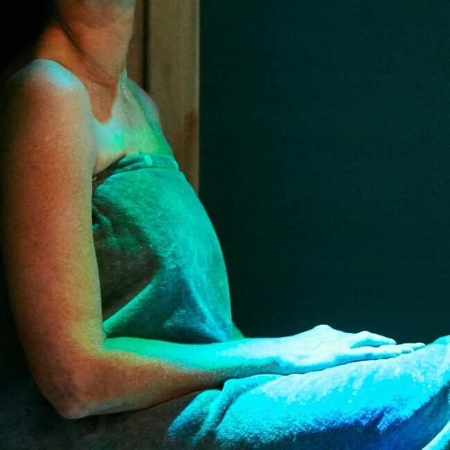 Woman relaxing in an infrared sauna